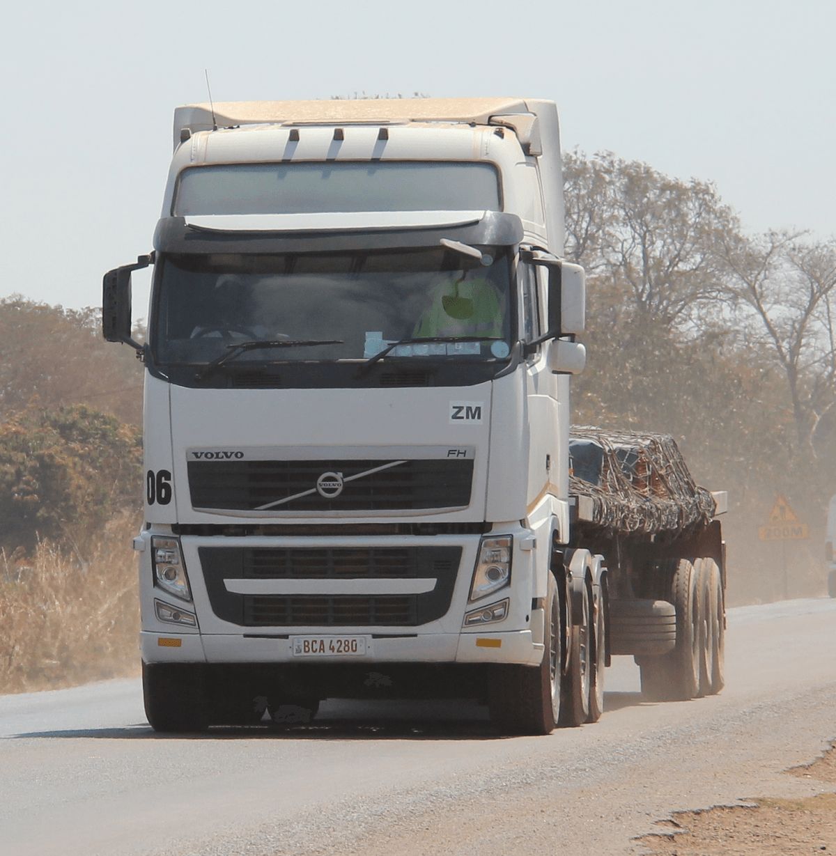 A JAAF truck carrying a loaded trailer on the road