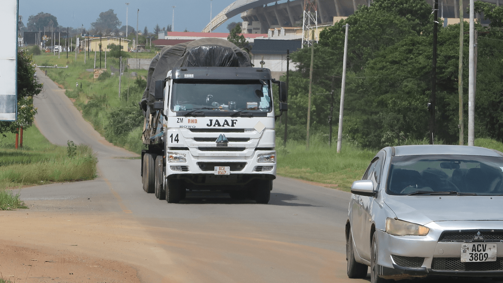 A JAAF truck carrying a covered load on the road
